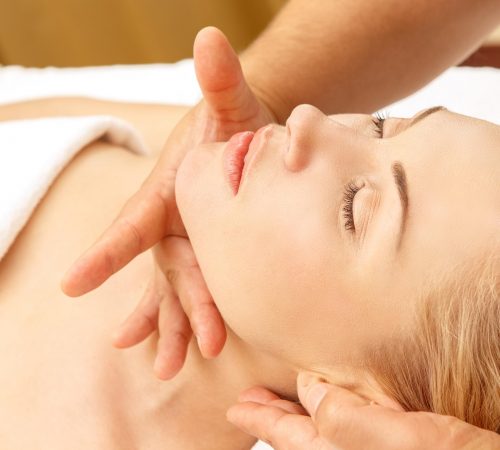 Lady receiving a face and head massage
