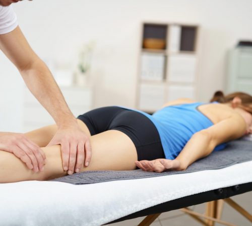 Sports massage on lady back of the leg