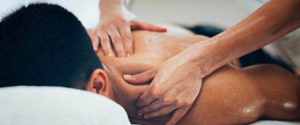 Sports massage on the man upper back